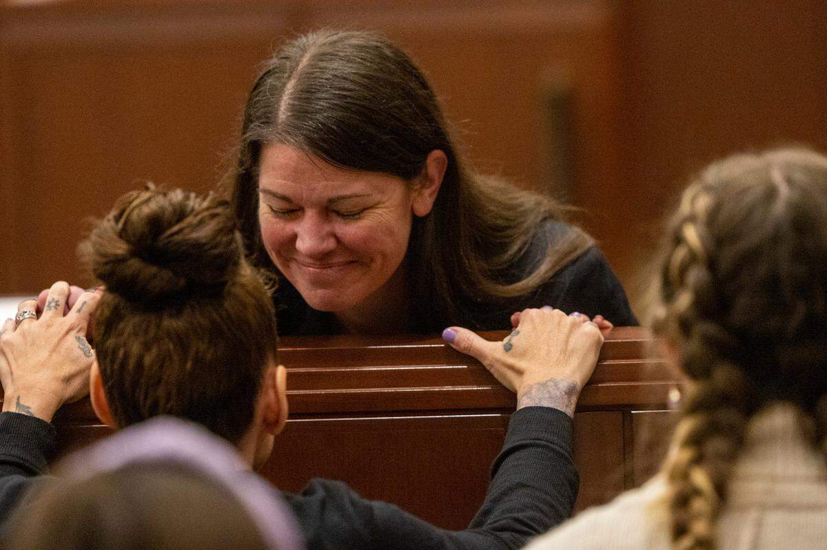 Prosecutor Kathryn Pomeroy, facing camera, comforts Melanie Tucker, the mother of Monica Moynan, after Brian Sluss was found guilty in the 2019 murder of his Moynan in Wake County District Court Thursday, April 28, 2022. Moynan, who shared two children with Sluss, was reported missing in mid-July of 2019, and her body has never been found.