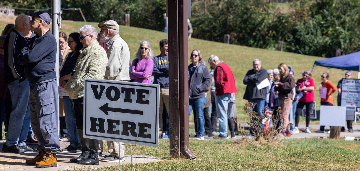 Voters wait in line to cast their ballots on the first day of early voting, on Thursday, October 17, 2024, at the Leicester Community Center in Leicester, N.C.