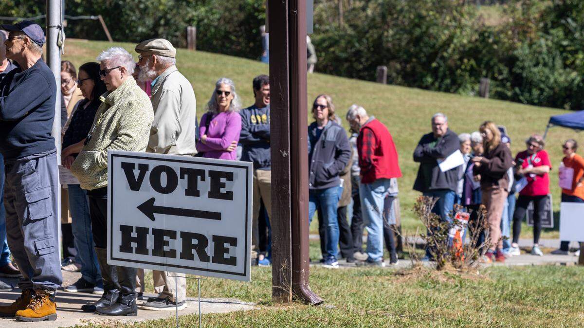 Voters wait in line to cast their ballots on the first day of early voting, on Thursday, October 17, 2024, at the Leicester Community Center in Leicester, N.C.