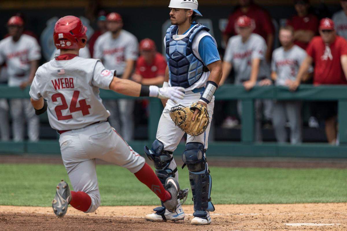 Arkansas Braydon Webb (24) scores on a base hit by Brady Slavens (17) in the fifth inning to give the Razorbacks a 3-0 lead over North Carolina during the first game of their Super Regional series on Saturday, June 11, 2022 at Boshamer Stadium in Chapel Hill, N.C.