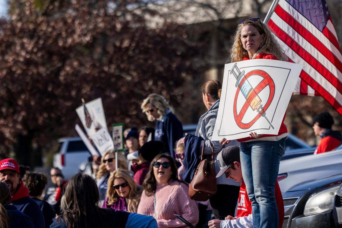 Demonstrators opposed to vaccine requirements protest outside the The N.C. Commission for Public Health in Raleigh Wednesday, Feb. 2, 2022. The commission unanimously voted against a rule-making petition from four UNC System professors to add the COVID vaccine to state immunization requirements for people who are 17 years old or who are entering 12th grade as of July 1.