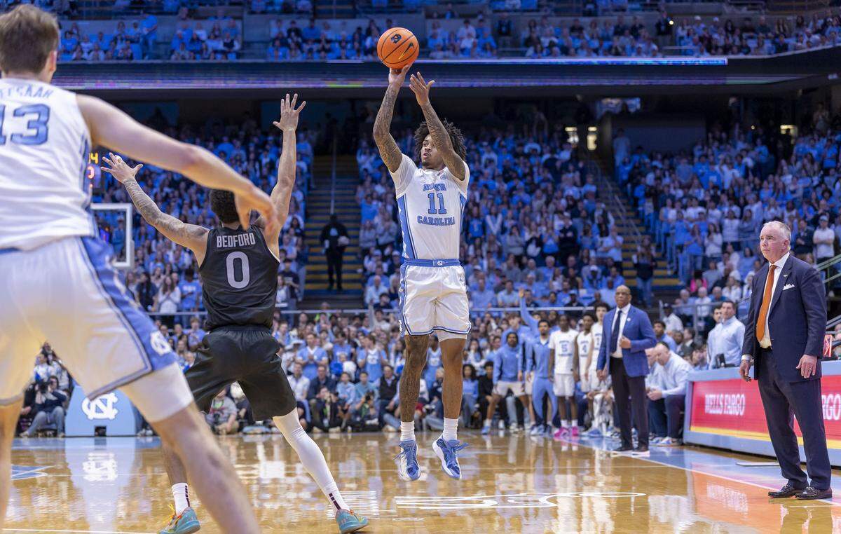 North Carolina guard Jonathan Powell (11) launches a three-point shot in the first half against Virginia Tech guard Jailen Bedford (0) on Saturday, February 28, 2026 at the Smith Center in Chapel Hill, N.C.