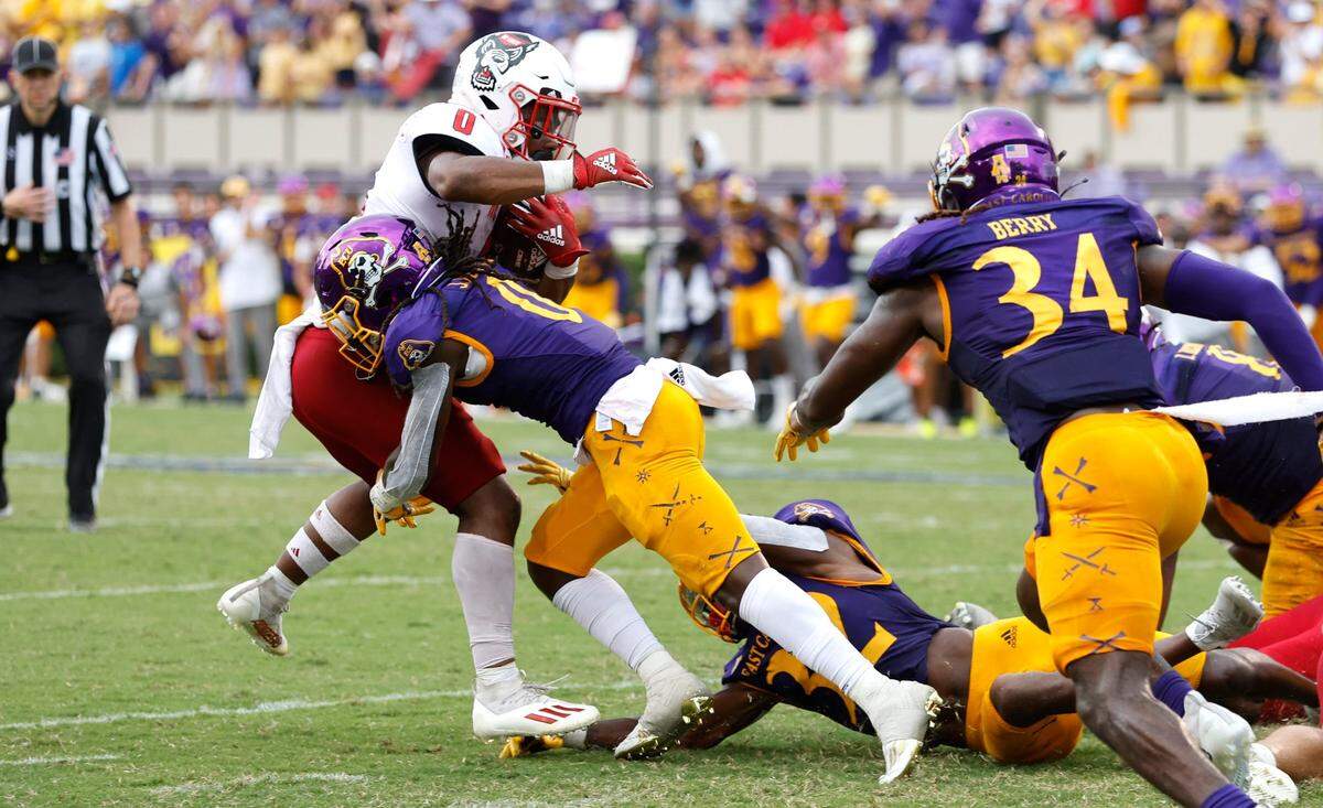 On fourth and goal, N.C. State running back Demie Sumo-Karngbaye (0) is stopped by East Carolina cornerback Juan Powell (0) to turn the ball over on downs in the second half of N.C. States 21-20 victory over ECU at Dowdy-Ficklen Stadium in Greenville, N.C., Saturday, Sept. 3, 2022.