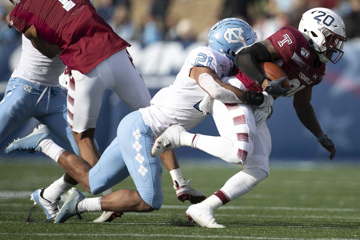 North Carolina’s Chazz Surratt (21) stops Temple’s (20) Re’Mahn Davis (20) in the second quarter during the Military Bowl on Friday, December 27, 2019 at Navy-Marine Corps Memorial Stadium in Annapolis, Maryland.
