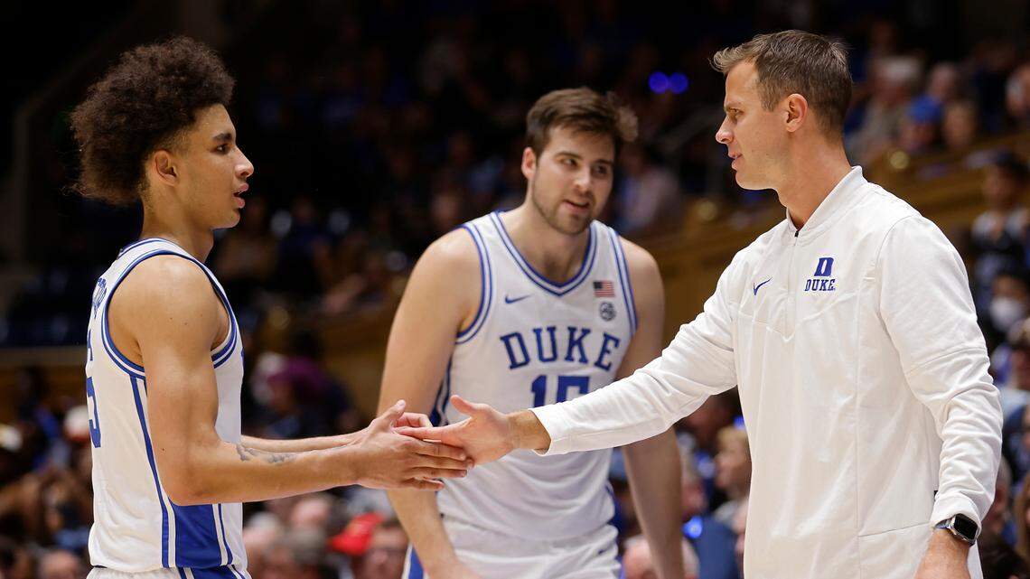 Duke Blue Devils head coach Jon Scheyer low fives Duke Blue Devils guard Tyrese Proctor during the first half of an exhibition game against Fayetteville State at Cameron Indoor Stadium on Wednesday, Nov. 2, 2022, in Durham, N.C.
