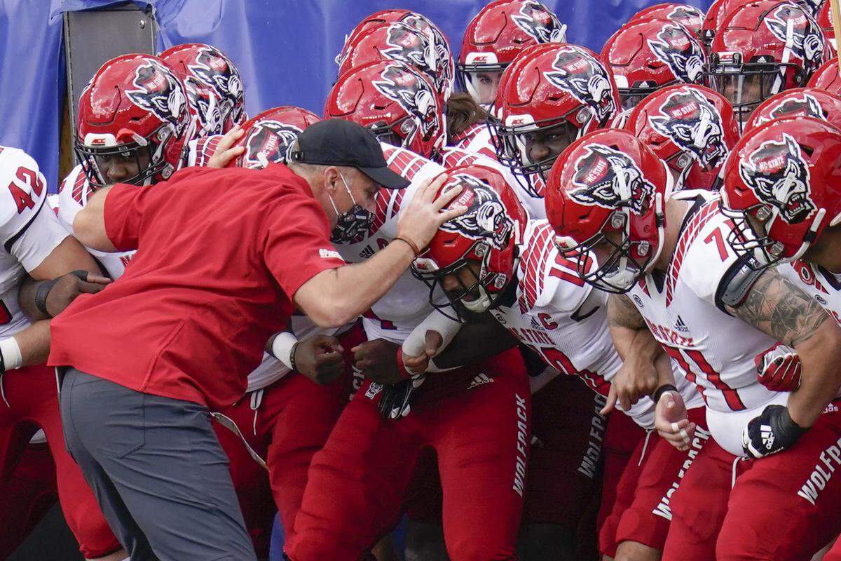 North Carolina State head coach Dave Doeren leads his team onto the field before playing Pittsburgh in an NCAA college football game, Saturday, Oct. 3, 2020, in Pittsburgh.