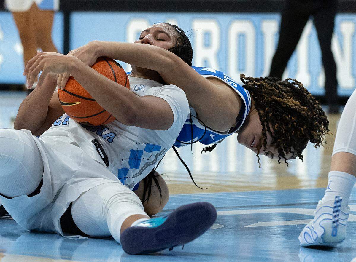 North Carolina’s Reniya Kelly wrestles for possession with Duke’s Delaney Thomas during the second half of the Tar Heels’ 53-46 overtime victory on Thursday, Jan. 9, 2025, at Carmichael Arena in Chapel Hill, N.C.