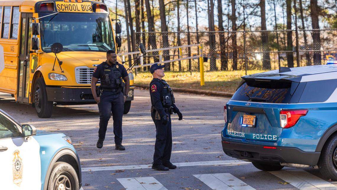 Police block an entrance at Southeast Raleigh High School on Nov. 27, 2023 after a student was fatally stabbed on campus. It’s one of the school crimes included in a new state report.