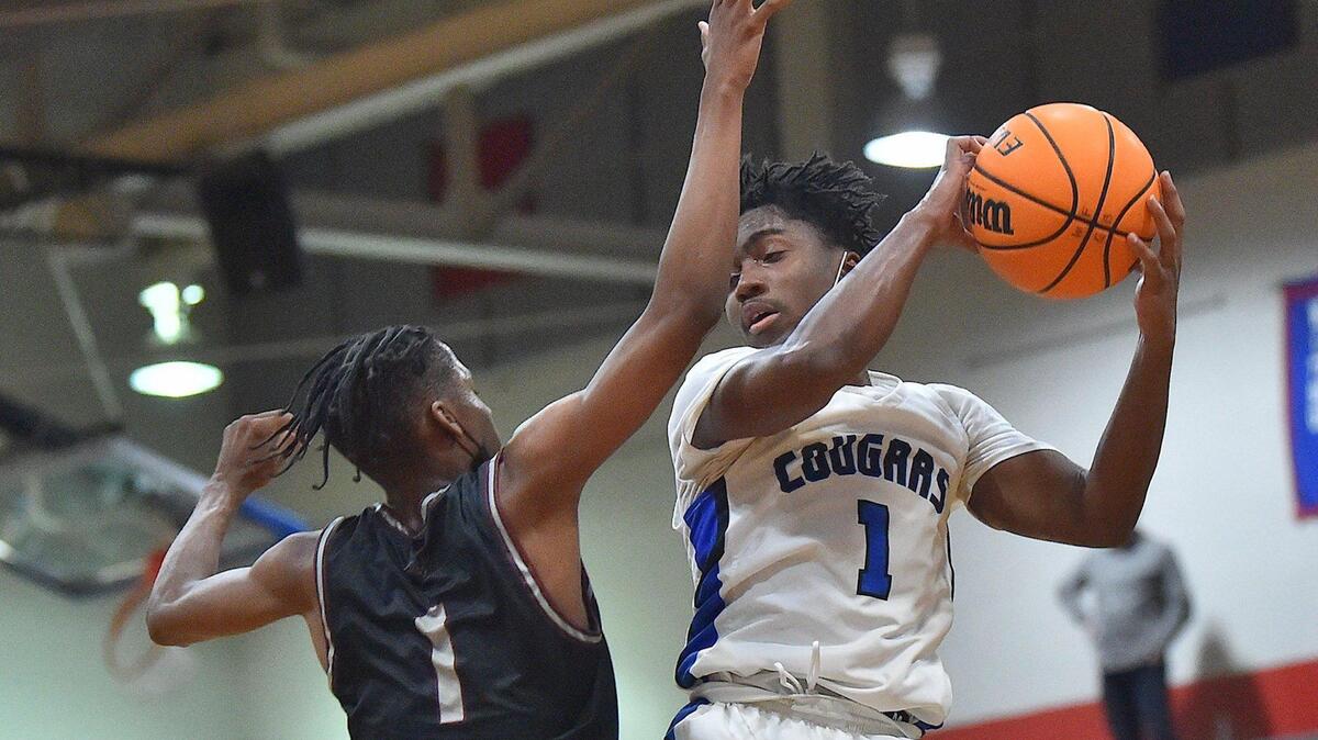Wake Forest’s Nigel Lucas (1) secures the rebound against Wakefield’s Ellija Preddy (1) during the second half. The Wakefield Wolverines and the Wake Forest Cougars met in a conference basketball game in Wake Forest, NC on January 14, 2022.