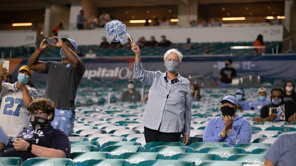 A small group of North Carolina fans cheers on the Tar Heels as they enter Hard Rock Stadium for their game against Texas A&M in the Capital One Orange Bowl on Saturday, January 2, 2021 in Miami Gardens, Florida. Approximately 14,000 fans will allowed into the stadium due to the COVID-19 pandemic.