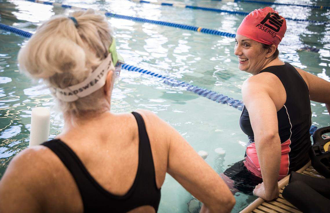 Andrea Peet, right, and her mother Sandra Lytle, left, talk as they exercise in the pool at Life Time Fitness in Cary, N.C. on Feb. 17, 2020. Peet, who is in her sixth year of living with ALS, gets a lot out of the twice weekly workouts. “I love being in the water, because I can’t fall,” she said.