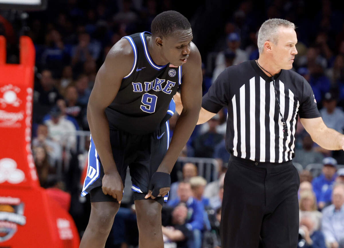 Duke’s Khaman Maluach (9) cramps up during the second half of Kentucky’s 77-72 victory over Duke in the State Farm Champions Classic in Atlanta, Ga., Tuesday, Nov. 12, 2024. Maluach would leave the game to get treatment.
