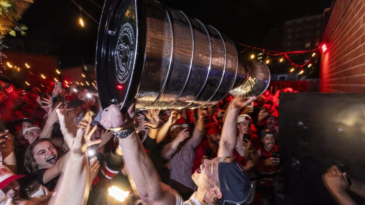 Carolina Hurricanes fans celebrate the team's Stanley Cup Final victory at Teets in Raleigh's Glenwood South district as the Stanley Cup, accompanied by Hurricanes players and staff, makes an appearance during a victory celebration Monday, June 15, 2026. The Hurricanes defeated the Vegas Golden Knights 4-2 in the Stanley Cup Final to win the franchise's second championship since 2006.