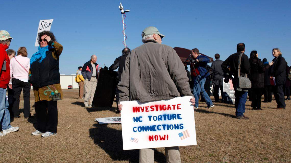 Demonstrators and media assemble for a press conference organized by Stop Torture Now Thursday, January 19, 2012, at the Johnston County airport. The group released a lengthy report from the UNC law school outlining what a team of lawyers and law students there believe are violations of state and federal laws by the employees of Aero Contractors, Ltd. 
