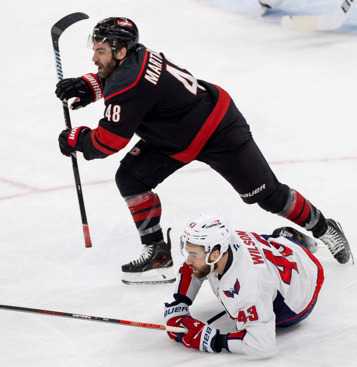 Carolina Hurricanes left wing Jordan Martinook (48) skates away from Washington Capitals right wing Tom Wilson (43) after checking him to the ice in the second during Game 3 of their series on Saturday, May 10, 2025 at Lenovo Center in Raleigh, N.C.