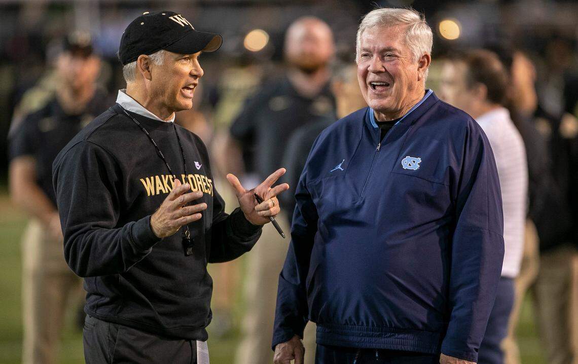 North Carolina coach Mack Brown talks with Wake Forest coach Dave Clawson prior to their game on Saturday, November 12, 2022 at Truist Field in Winston-Salem, N.C.