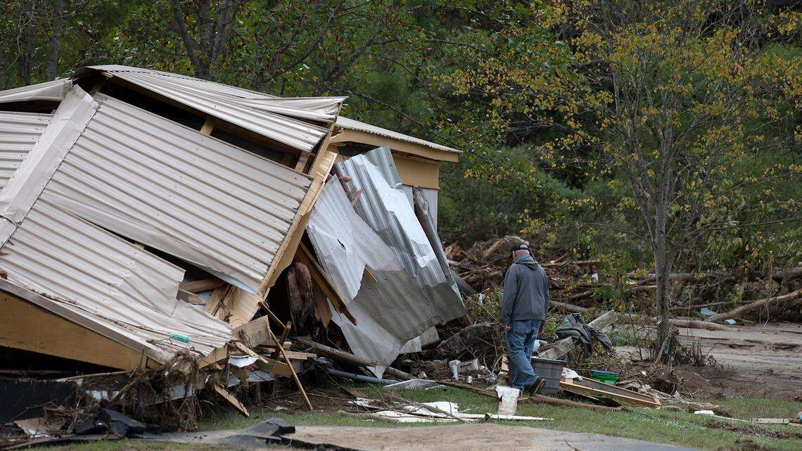 The severe damage Hurricane Helene brought to thousands of homes across Western North Carolina may be causing the expected pace of well water testing to lag, state health officials said. This photo shows a person walking near a demolished building in the unincorporated Avery County community of Frank, N.C., on Oct. 1, just days after Helene caused devastation across the region.