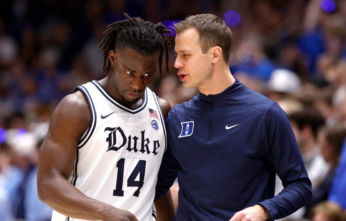 Duke head coach Jon Scheyer talks with Sion James (14) during the second half of Duke’s 87-70 victory over UNC at Cameron Indoor Stadium in Durham, N.C., Saturday, Feb. 1, 2025.