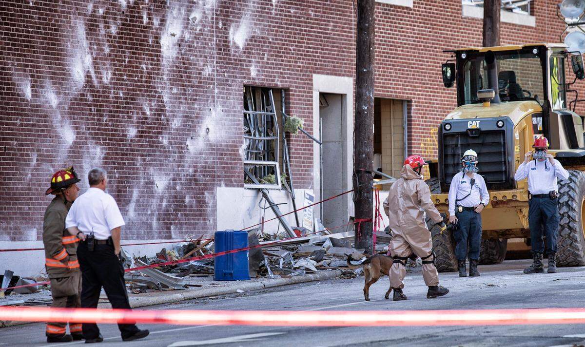 A member of the State Bureau of Investigations prepares to enter the collapsed structure with a search dog on Duke St. in Durham on Thursday, April 11, 2019. Search and rescue crews worked around the clock after fires were contained to make sure no one was trapped under the rubble after an explosion occurred Wednesday.
