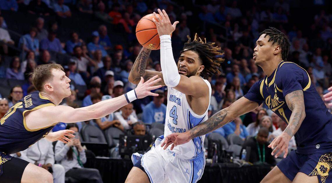North Carolina’s RJ Davis (4) drives by Notre Dame’s Matt Allocco (41) and Tae Davis (7) during the first half of UNC’s game against Notre Dame in the second round 2025 of the ACC Men’s Basketball Tournament at the Spectrum Center in Charlotte, N.C., Wednesday, March 12, 2025.