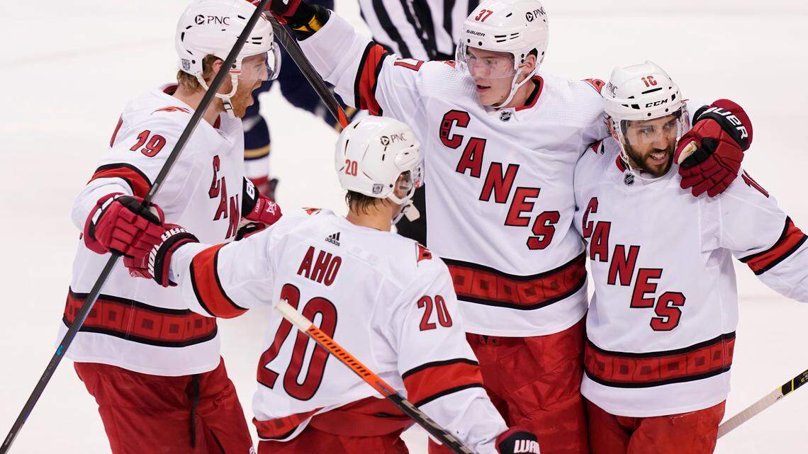 Carolina Hurricanes right wing Sebastian Aho (20) right wing Andrei Svechnikov (37) and defenseman Dougie Hamilton (19) celebrate a goal by center Vincent Trocheck (16) during the first period at an NHL hockey game against the Florida Panthers, Saturday, Feb. 27, 2021, in Sunrise, Fla. Hamilton and Svechnikov got the assist. (AP Photo/Marta Lavandier)