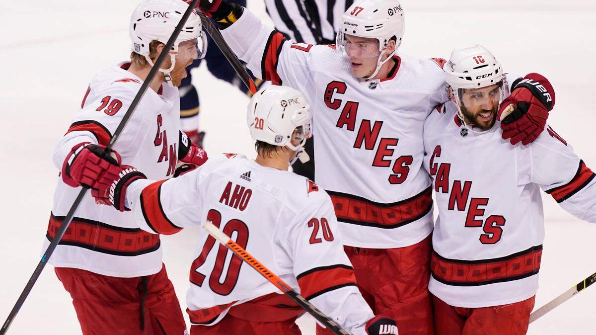Carolina Hurricanes forward Sebastian Aho (20) Andrei Svechnikov (37) and defenseman Dougie Hamilton (19) celebrate a power-play goal by center Vincent Trocheck (16) during the first period at an NHL hockey game against the Florida Panthers, Saturday, Feb. 27, 2021. (AP Photo/Marta Lavandier)