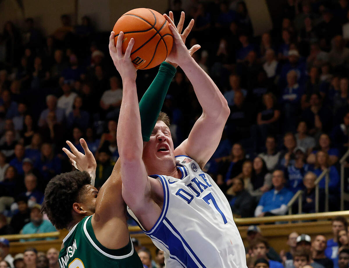 Duke’s Kon Knueppel drives to the basket past George Mason’s Zach Anderson during the first half of the Blue Devils’ 68-47 win on Tuesday, Dec. 17, 2024, at Cameron Indoor Stadium in Durham, N.C.