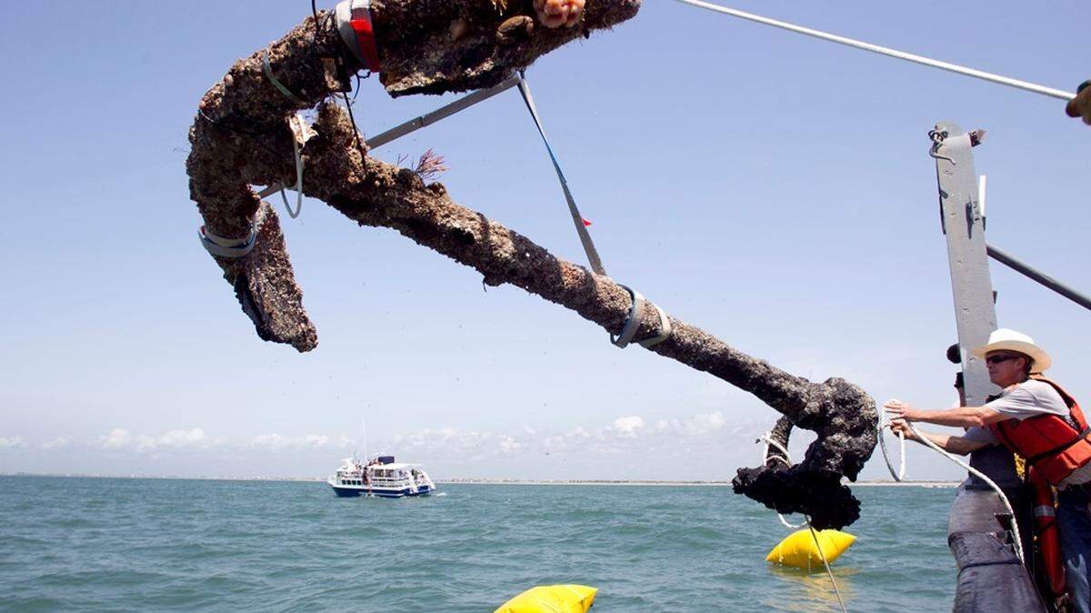 A 3,000-pound anchor from Blackbeard's Queen Anne's Revenge is recovered on May 27, 2011, from the ocean where it has been since 1718 in Beaufort Inlet. N.C. Crew member Mitchel Gilliland, right, helped guide the anchor aboard the Dan K. Moore.