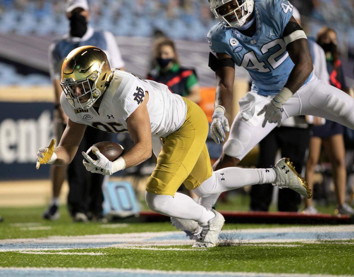 Notre Dame’s George Takacs (85) gets past North Carolina’s Tyrone Hopper (42) picking up 13 yards on a pass completion from quarterback Ian Book (12) to set up Notre Dame’s final score late in the fourth quarter, and secure their 31-17 victory over North Carolina.