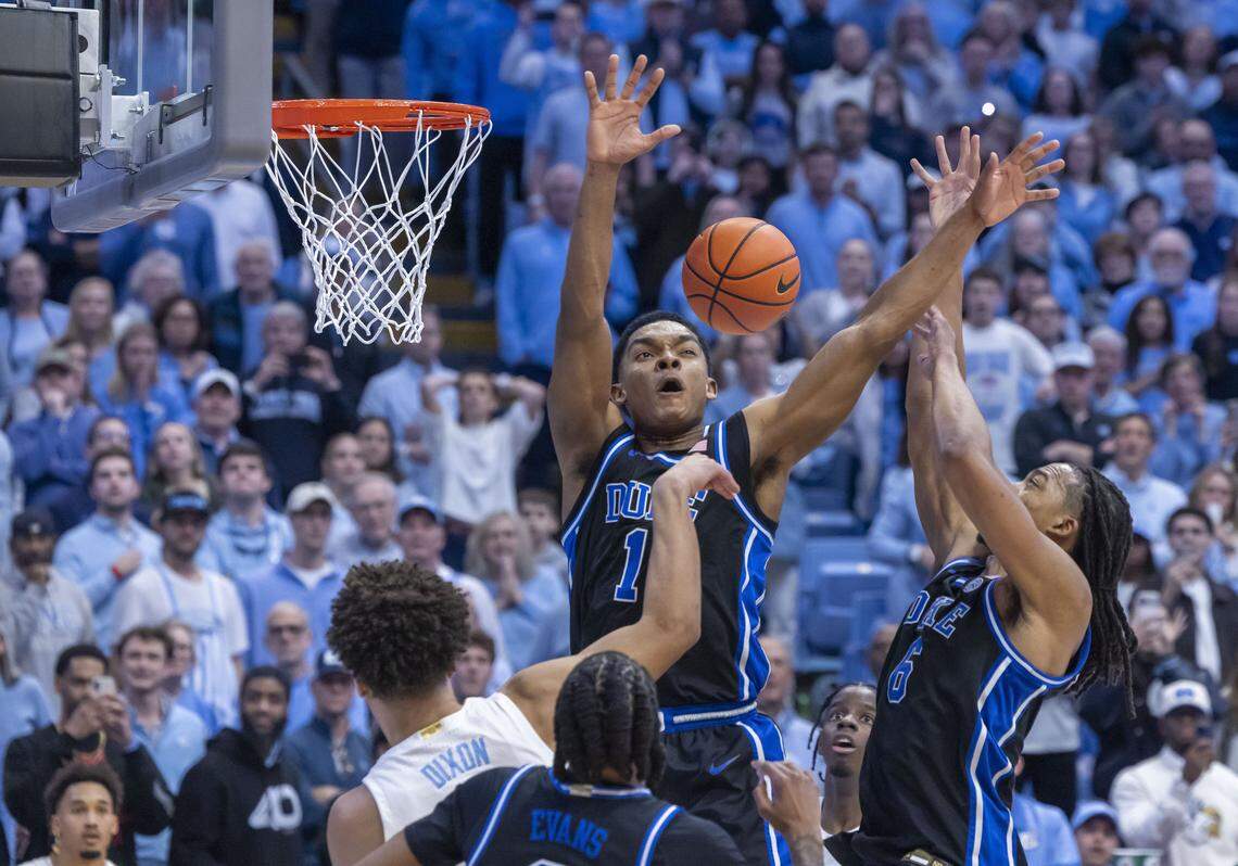 North Carolina guard Derek Dixon passes out a trap by Duke guard Caleb Foster and forward Maliq Brown to Seth Trimble in the final seconds of play, setting up Trimble’s winning basket, on Feb. 7, 2026, at the Smith Center in Chapel Hill, N.C.