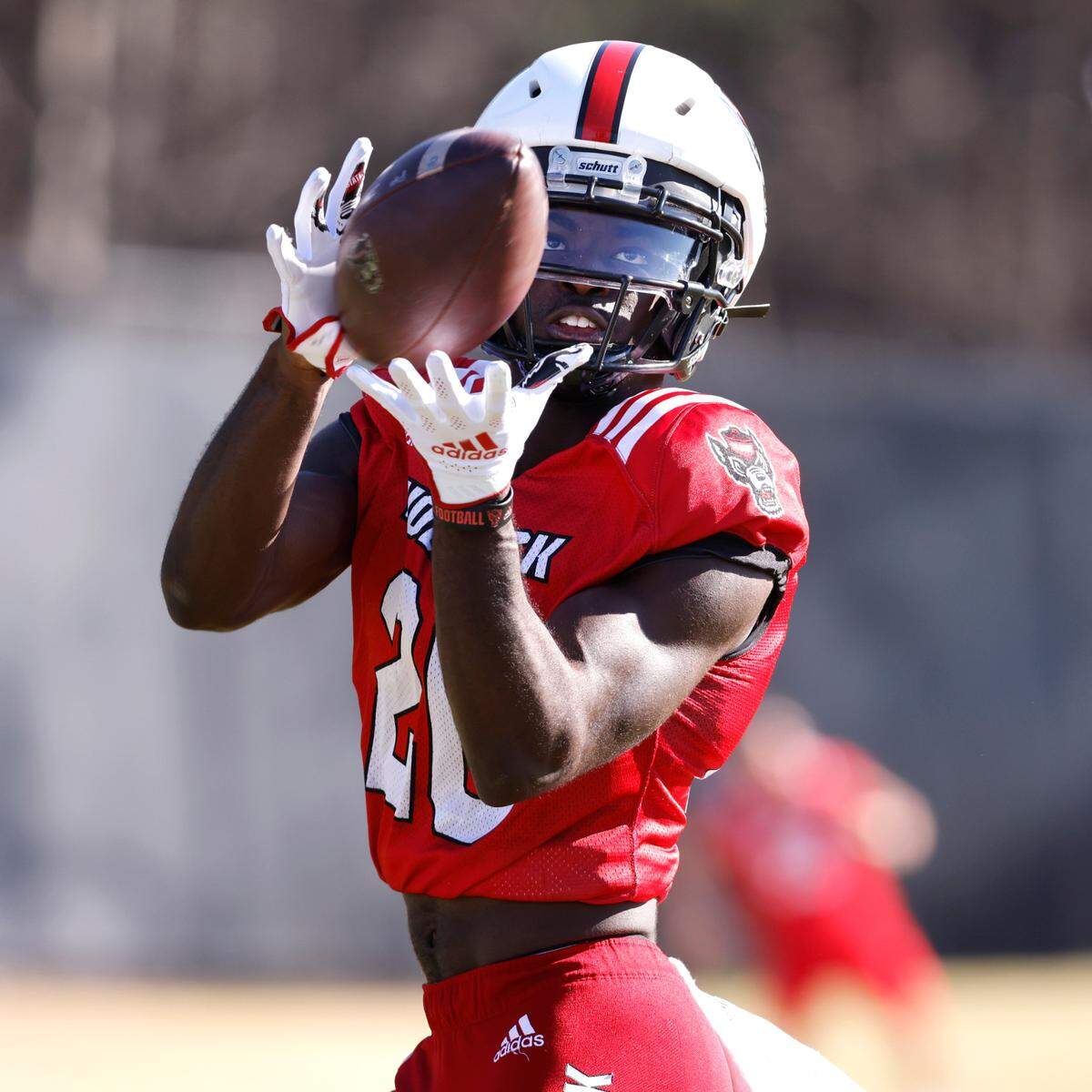 N.C. State wide receiver Julian Gray (20) pulls in the pass during the first day of the Wolfpack’s spring football practice in Raleigh, N.C., Wednesday, March 2, 2022.