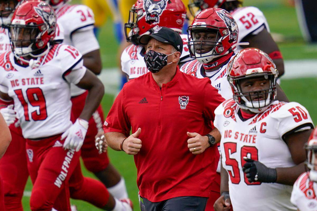 North Carolina State head coach Dave Doeren takes the field with his team before an NCAA college football game against Pittsburgh, Saturday, Oct. 3, 2020, in Pittsburgh. North Carolina State won 30-29.