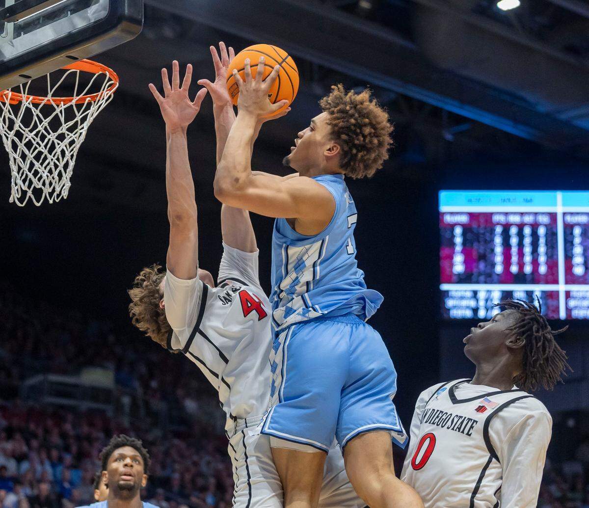North Carolina guard Seth Trimble (7) puts up a shot against San Diego State’s Wayne McKinney III (3) and Magoon Gwath (0) in the first half during the NCAA First Four on Tuesday, March 18, 2025 at the University of Dayton Arena in Dayton, Ohio.