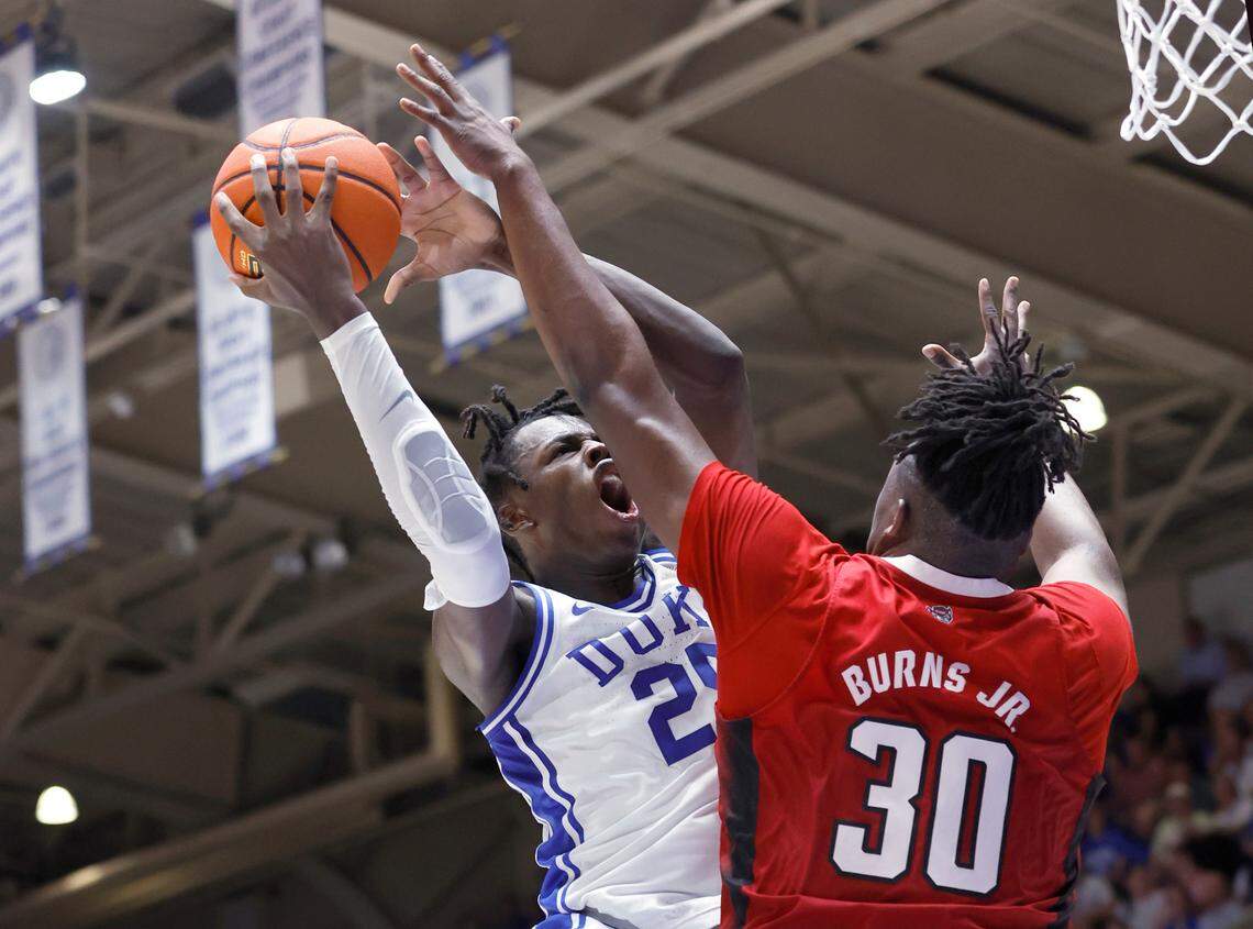 Duke’s Mark Mitchell (25) shoots as N.C. State’s D.J. Burns Jr. (30) defends during the first half of N.C. State’s game against Duke at Cameron Indoor Stadium in Durham, N.C., Tuesday, Feb. 28, 2023.