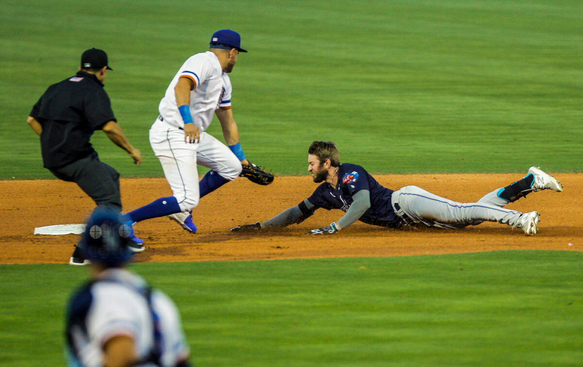 Durham Bulls’ Jonathan Aranda (21) misses a tag on Jacksonville Jumbo Shrimp’s Brian Miller (5) at second base during the Bulls’ season opener against at the Durham Bulls Athletic Park,Tuesday, April 12, 2022.