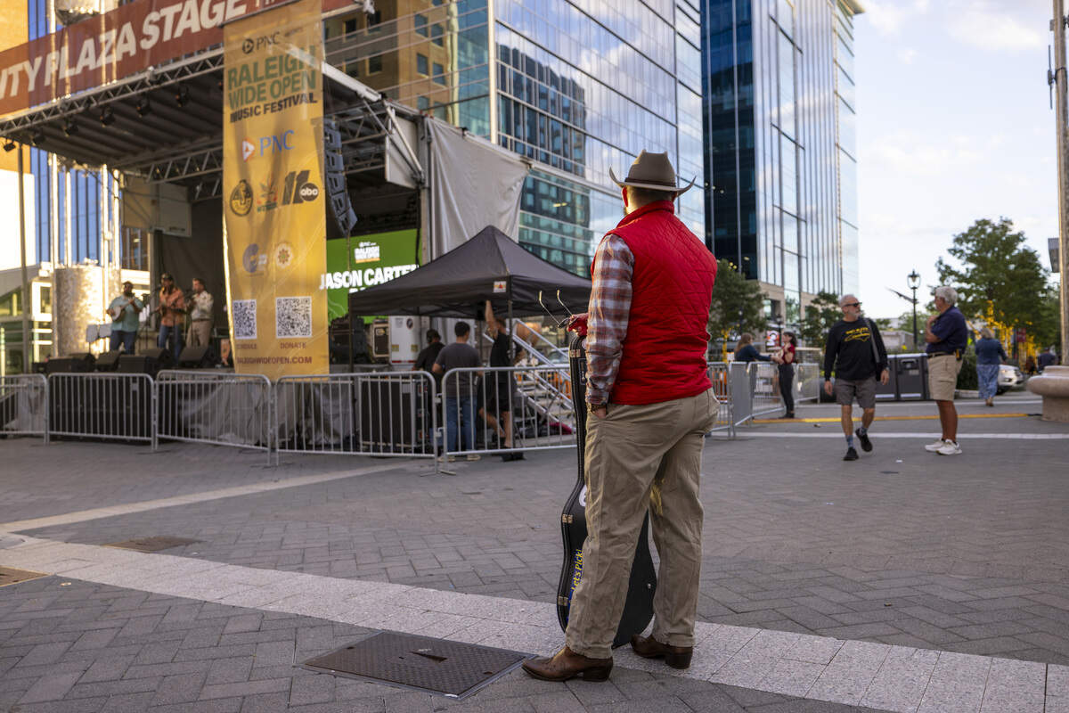 Festival-goers enjoy a live performance by the Jason Carter Band in City Plaza during the Raleigh Wide Open music festival in downtown Raleigh on Friday, Oct. 3, 2025. The event features live bluegrass, folk, Americana and gospel artists.