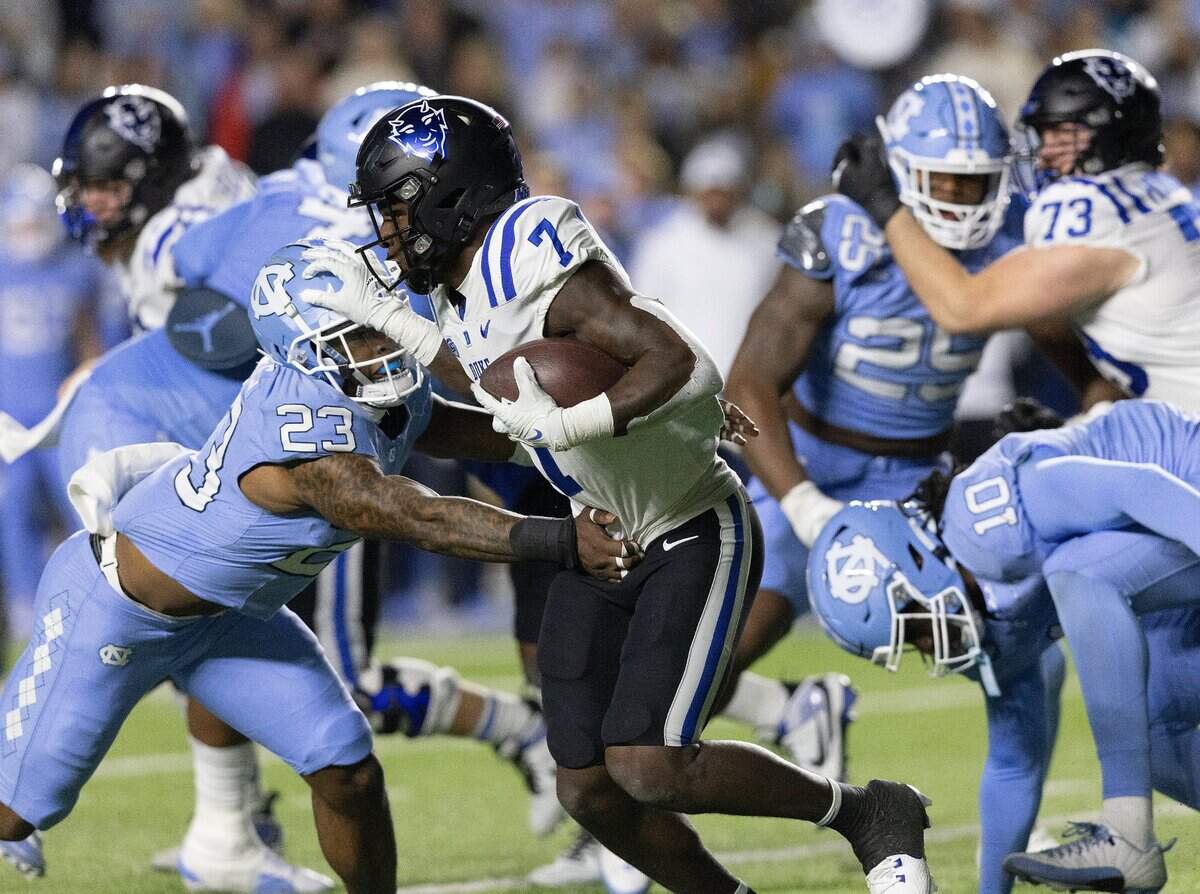 Duke’s Jordan Waters runs the ball under pressure from North Carolina’s Power Echols during the first half of the Blue Devils’ game on Saturday, Nov. 11, 2023, at Kenan Stadium in Chapel Hill, N.C.