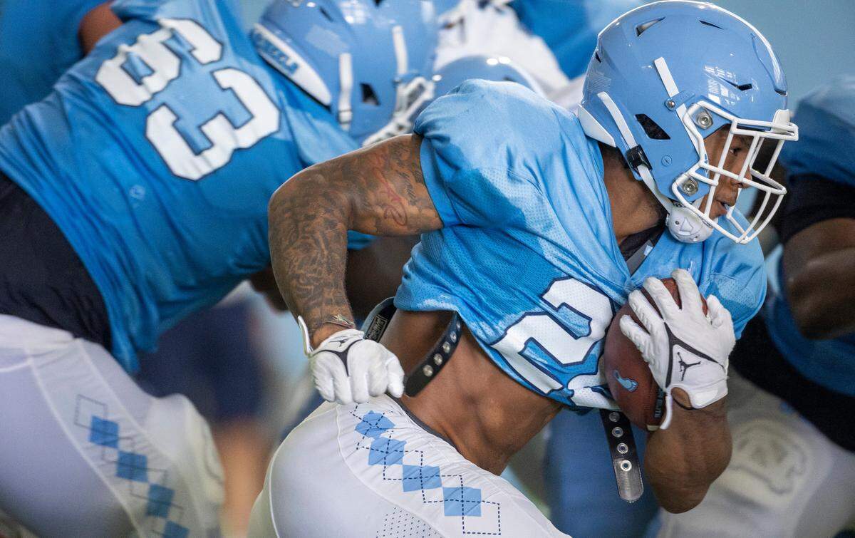 North Carolina running back Omarion Hampton (28) carries the ball during the Tar Heels’ practice on Tuesday, August 8, 2023 in Chapel Hill, N.C.