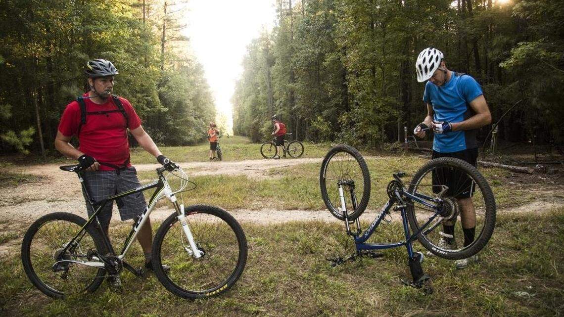 Cyclists and half-brothers Brian Maxwell of Knightdale, left, and Derek Hansen, right, of Benson prepare to bike the popular mountain bike trails on RDU Airport Authority’e FATS tract leased by the Lake Crabtree County Park Wednesday, October 8, 2014.