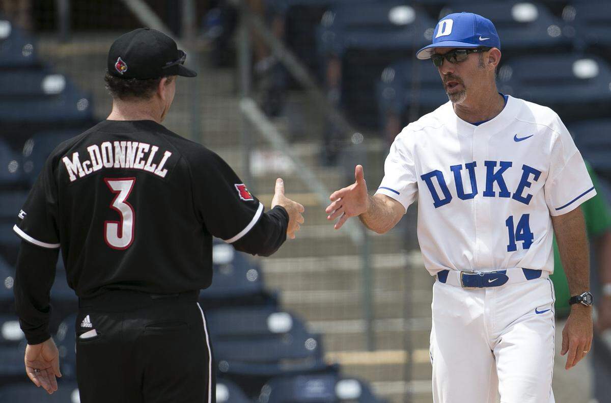 Duke coach Chris Pollard shakes hands with Louisville coach Dan McDonnell following the Cardinals’ 9-2 victory in the ACC tournament on Friday, May 25, 2018, at Durham Bulls Athletic Park in Durham, N.C.