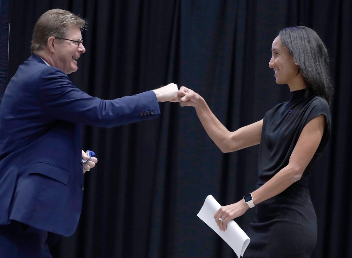 Nina King fist-bumps Duke President Vincent Price during a press conference where King was introduced as Duke’s new athletic director at Cameron Indoor Stadium in Durham, N.C., Friday, May 21, 2021.