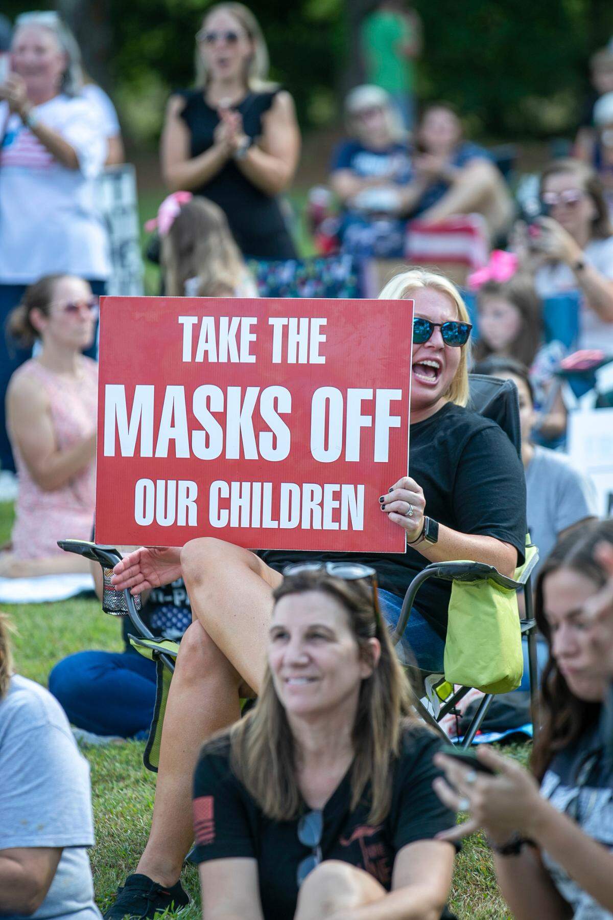 Demonstrators opposing a mask mandate gather outside the Johnston County Board of Education meeting on Sept. 14, 2021, in Smithfield. Some North Carolina school districts are now dropping face mask mandates for the first time since the start of the COVID-19 pandemic nearly two years ago.