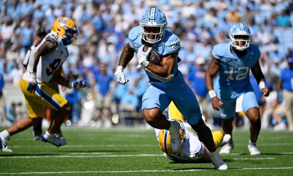 North Carolina Tar Heels running back Omarion Hampton (28) runs with the ball as Pittsburgh Panthers defensive lineman Nate Matlack (2) defends in the second quarter at Kenan Memorial Stadium.