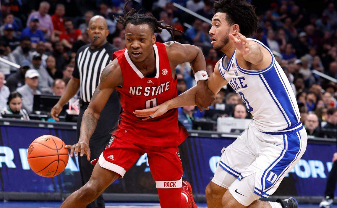 N.C. State’s DJ Horne (0) drives by Duke’s Jared McCain (0) during the second half of N.C. State’s 74-69 victory over Duke in the quarterfinal round of the 2024 ACC Men’s Basketball Tournament at Capital One Arena in Washington, D.C., Thursday, March 14, 2024.