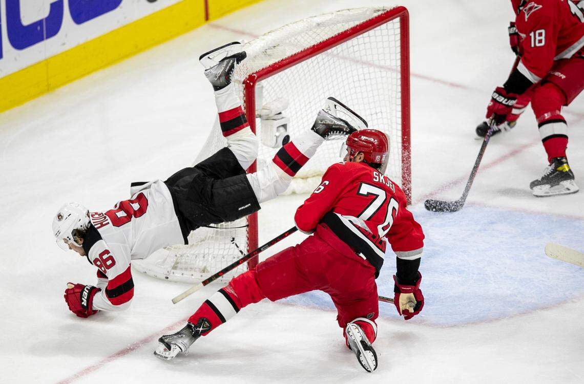 The New Jersey Devils Jack Hughes (86) flips over the Carolina Hurricanes Brady Skjei (76 )in the second period during Game 5 of their second round Stanley Cup playoff series on Thursday, May 11, 2023 at PNC Arena in Raleigh, N.C.