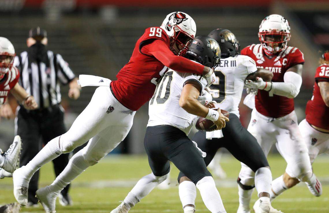 N.C. State defensive end Daniel Joseph (99) sacks Wake Forest quarterback Sam Hartman (10) during the second half of N.C. State’s 45-42 victory over Wake Forest at Carter-Finley Stadium in Raleigh, N.C, Saturday, Sept. 19, 2020.