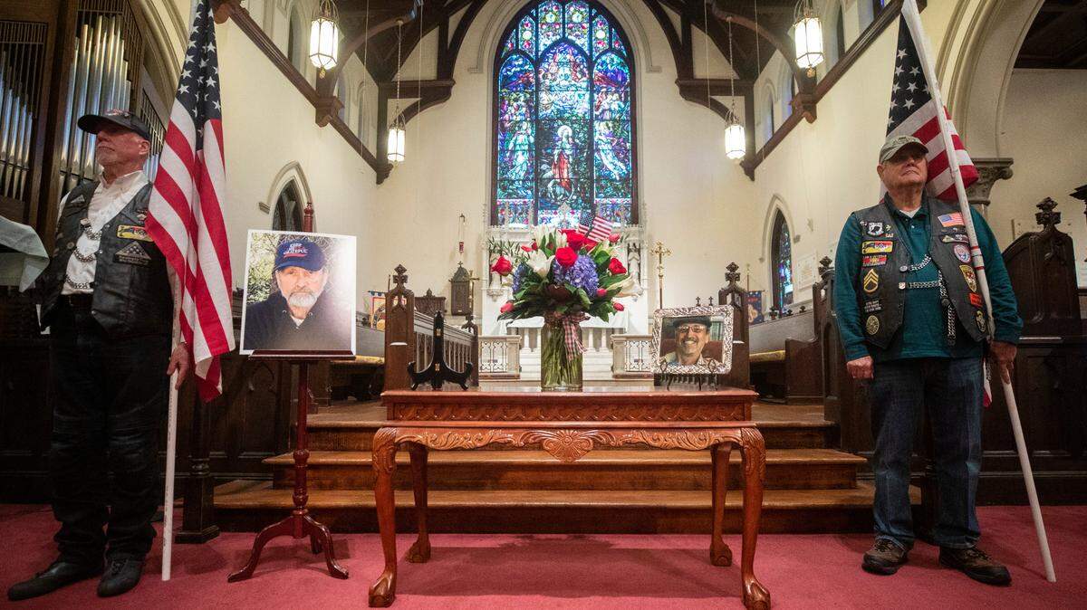 Patriot Guard Riders Mark Tuskey, left, and John Foster, right, stand in support of veteran Dominic Fiumara before the start of his funeral at the Church of the Good Shepard in Raleigh, N.C. on Veterans Day, Thursday, Nov. 11, 2021.