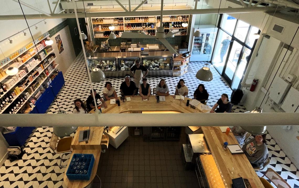 Cheesemonger Stevie Webb, co-owner of Wedgewood Cheese Bar in Carrboro, gathered his staff Friday in the newly renovated space for a wine and cheese tasting. The cheese bar seats 12, with a separate cheese counter for ordering slices and wheels.