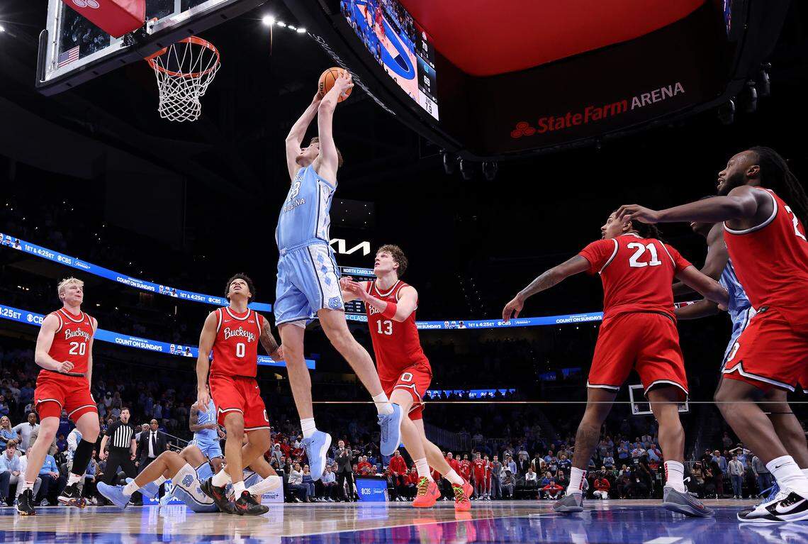 UNC’s Henri Veesaar (13) dunks the go-ahead basket in the final seconds against John Mobley Jr. (0) and Christoph Tilly (13) of Ohio State during their game at State Farm Arena on Dec. 20, 2025 in Atlanta, Georgia.