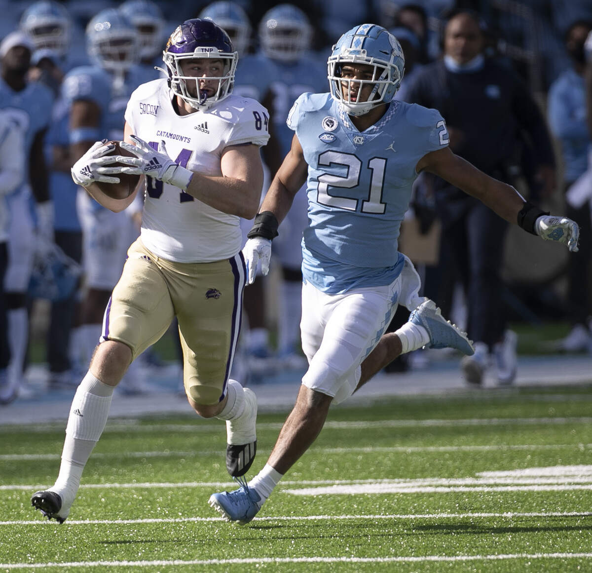 Western Carolina’s Owen Cosenke (84) races ahead of North Carolina linebacker Chazz Surratt (21) after a 40-yard pass reception from quarterback Reggie Jones in the second quarter on Saturday, December 5, 2020 at Kenan Stadium in Chapel Hill, N.C.